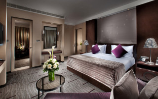 Hotel room bed table television - a vase of flowers free wallpaper