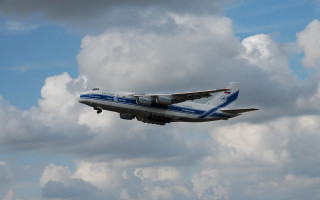 Large jetliner cloudy sky blue 2 - tail free wallpaper