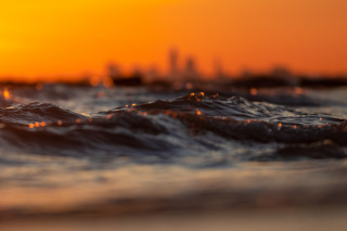 Blurry city skyline sunset waves 2 - orange sky free wallpaper