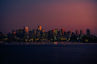 Cityscape night redsky boat water - a boat in the foreground free wallpaper for desktop