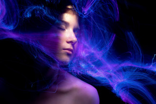 Woman wind streaks hologram light - her face and shoulders free wallpaper