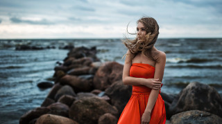Woman orange dress ocean rocks - an orange dress free wallpaper