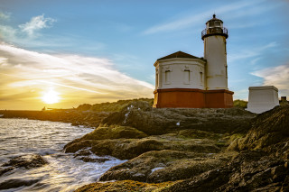 Lighthouse rocky shore sunset clouds 5 - a rocky shore free wallpaper for desktop