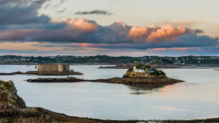 Large water island cloudy sunset - a small island in the middle of it free wallpaper