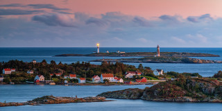 Lighthouse island ocean sunset beach - a lighthouse in the distance free wallpaper