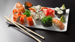 Sushi plate chopsticks black table - a plate of sushi free wallpaper