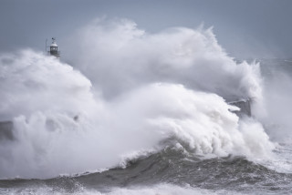 Lighthouse wave ocean cloudy stormy - a lighthouse in the background free wallpaper