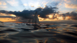 Sailboat ocean sunset cloudy sky 2 - a few cloud above free wallpaper