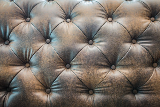 Leather upholstered wall buttons black - a white spot free wallpaper