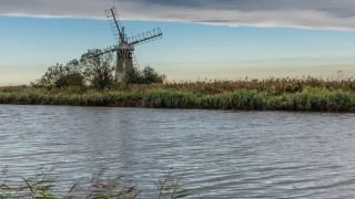 Windmill island river grass clouds - free ship wallpaper