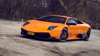 Bright orange sports car parking 3 - the background and a sign free wallpaper