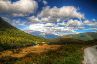 Scenic valley rainbow river mountains - a scenic view of a valley free wallpaper