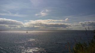 Sailboat cloudy sky lighthouse water - the water under a cloudy sky free wallpaper
