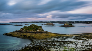 Lake island reflection cloudy sky - a small island in the middle of it free wallpaper