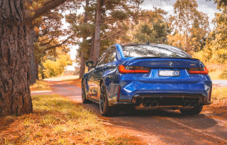 Blue car autumn leaves fire - the side of a road next free wallpaper