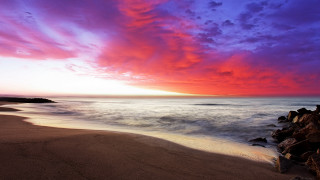 Beach rock outcropping sunset clouds - colorful cloud free wallpaper