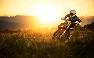 Dirt bike riding grassy field 2 - the background and sun free wallpaper