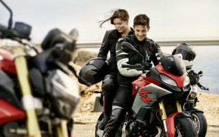 Biker couple motorcycle water bridge - the water and a bridge in the background free wallpaper