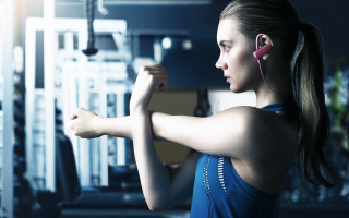 Woman gym earphones arm muscles - a barbell free wallpaper