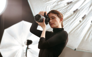 Woman holding camera gun white - a white umbrella free wallpaper