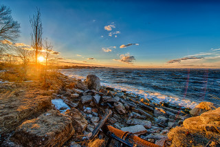Sunset rocky beach bench shore - a sunset over a rocky beach free wallpaper for desktop