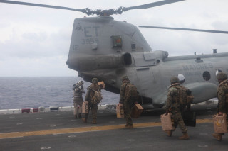 Soldiers walking helicopter ship ocean - a group of soldiers free wallpaper