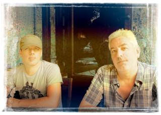 Two men sitting table food 2 - a plate of food in front free wallpaper