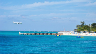 Plane beach pier umbrellas ocean - over a beach free wallpaper for desktop