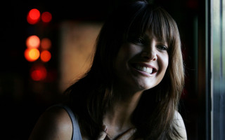 Woman smiling window night traffic - free light wallpaper