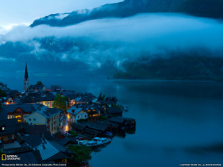 Town mountain water fog background - a mountain in the background and a body of water free wallpaper