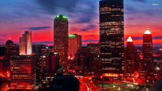 City skyline tall buildings nighttime 14 - a red sky in the background free wallpaper