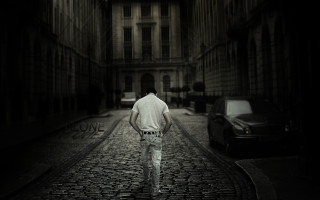 Man walking cobblestone street night - the side of the street free wallpaper