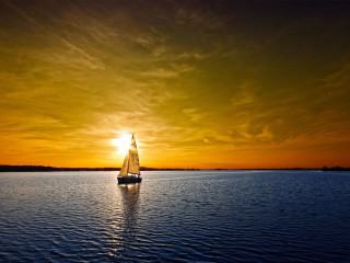 Sailboat sailing sunset dawn water - the sun setting behind free wallpaper