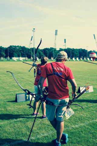 Man holding bow arrow field - boleslaw cybi free wallpaper for mobile