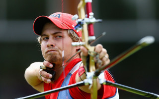 Man holding bow aiming red - a bow and arrow free wallpaper