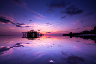 Purple sky reflections pier city - a building in the distance free wallpaper
