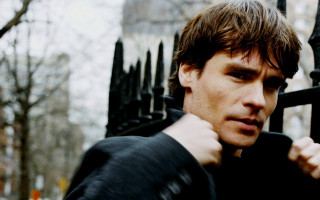 Man black fence serious look - his shoulder free wallpaper