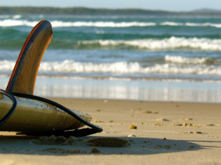 Surfboard sand beach ocean waves - a beach near the ocean free wallpaper