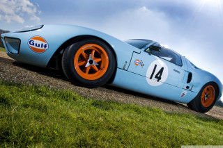 Blue racecar orange wheels dirtroad - a blue race car free wallpaper