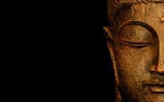 Buddha statue closeup black background - facial feature free wallpaper for desktop
