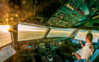 Man sitting cockpit plane pointing - the screen free wallpaper