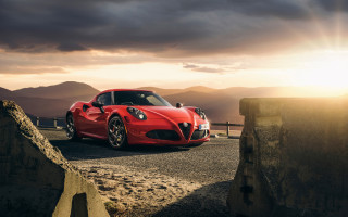 Red sports car mountain sunset 3 - a dark sky in the background free wallpaper