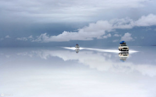 Boats floating water cloudy sky - a large body of water under a cloudy sky free wallpaper