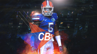 Football player helmet holding football 6 - a football player free wallpaper