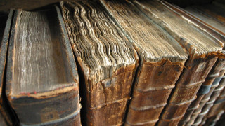Old books wooden table pile - old free wallpaper