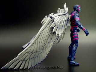 Angel wings glowing black background - a toy figure free wallpaper