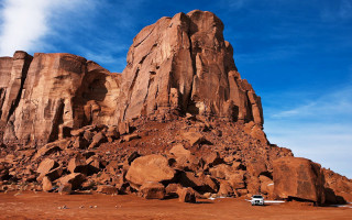 Car parked rock formation desert - large free wallpaper for desktop