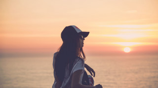 Woman beach sunset skateboard hat - her hand and a hat free wallpaper