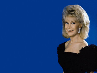 Woman black dress smiling blue - a blue background behind her free wallpaper for desktop