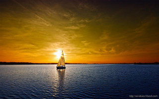 Sailboat sunset dawn water sailing - a sailboat free wallpaper